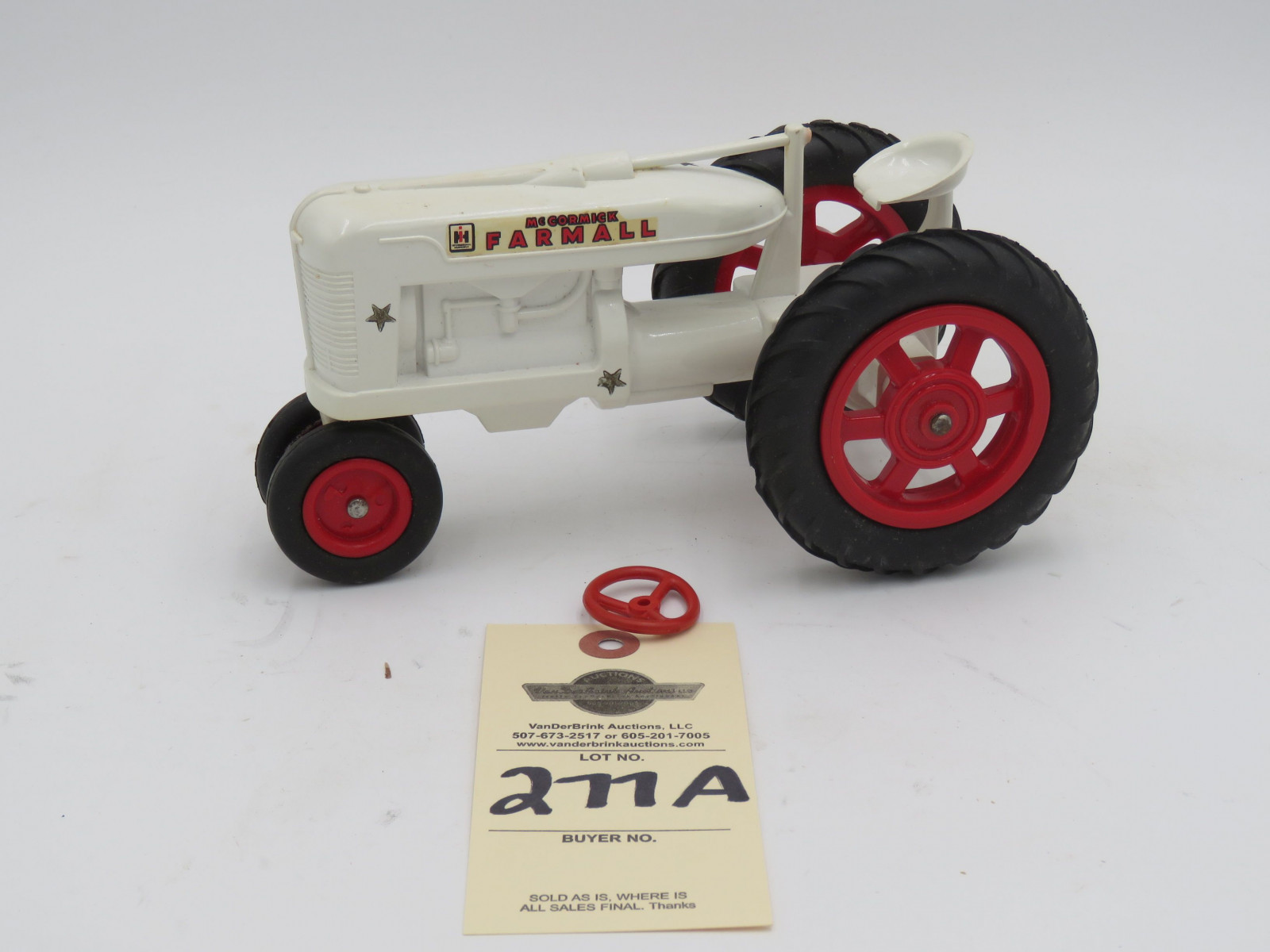 McCormick Farmall white plastic die-cast tractor. Opened box. Steering wheel  broke but provided in box. - Image 1