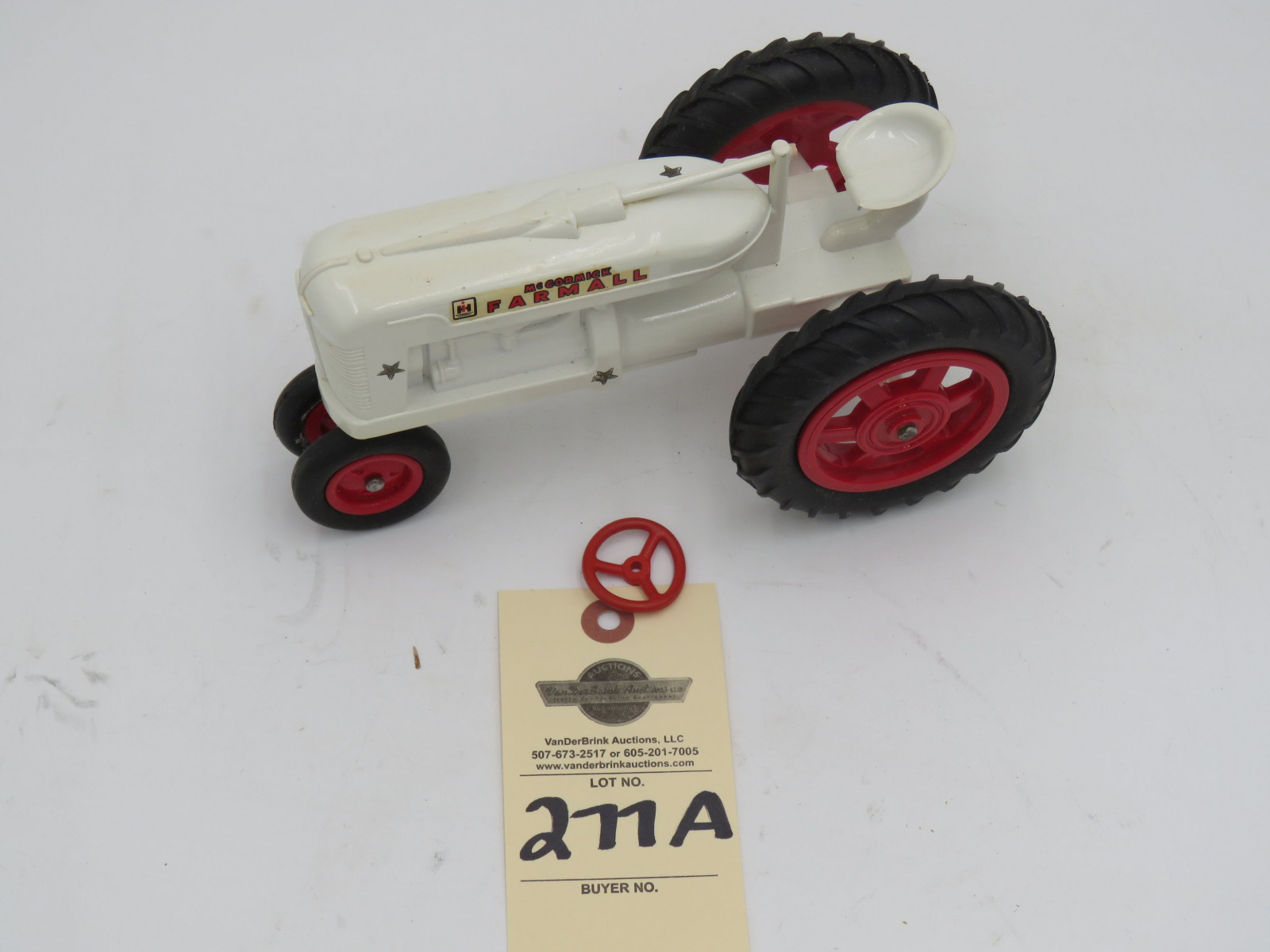 McCormick Farmall white plastic die-cast tractor. Opened box. Steering wheel  broke but provided in box. - Image 2
