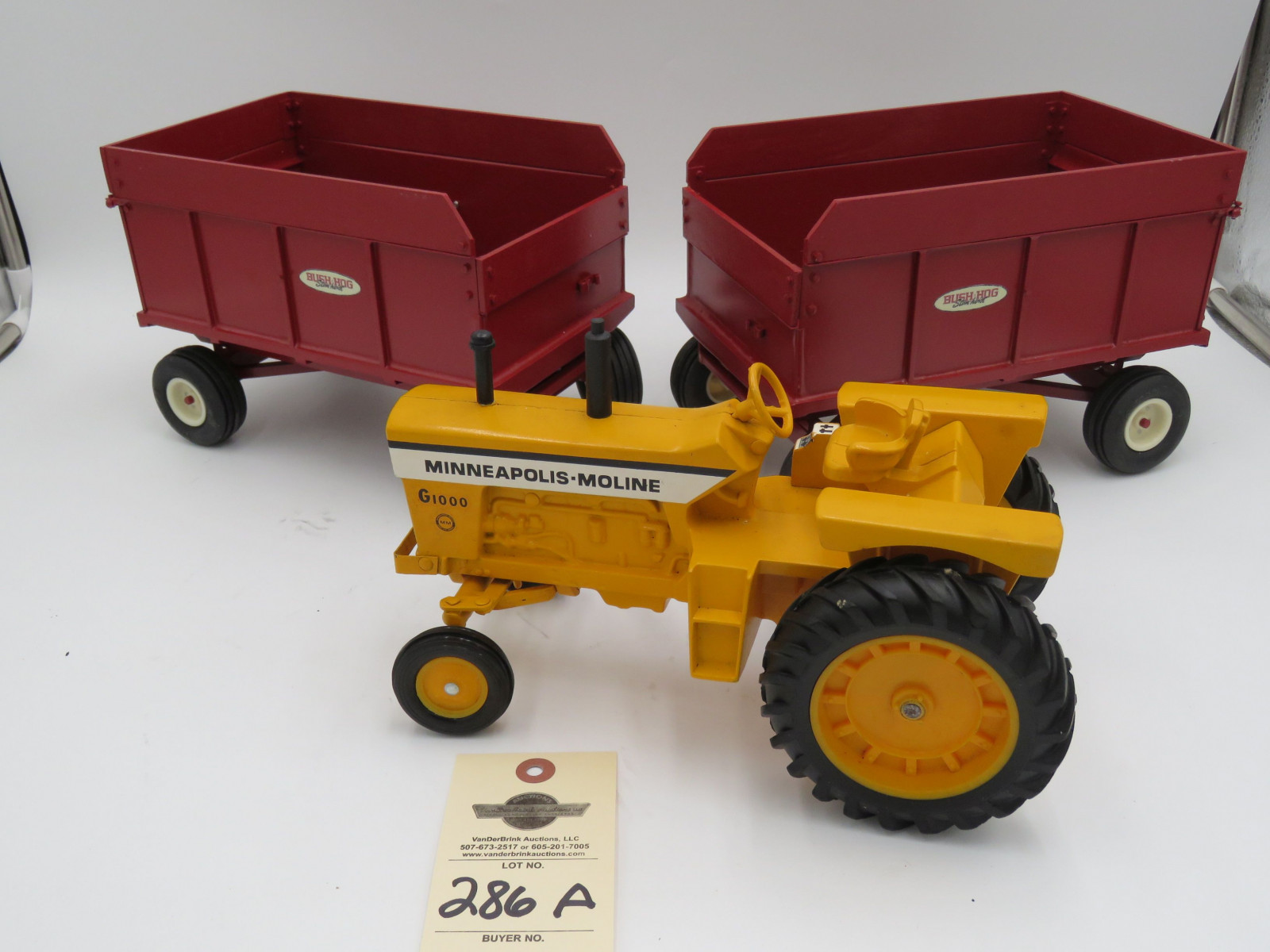 Minneapolis Moline G1000 Ertl metal die-cast tractor no box. 2 Bush Hog Stan Horst metal die cast wagons. No box. Sold as a set of 3. 1/16th Scale - Image 1